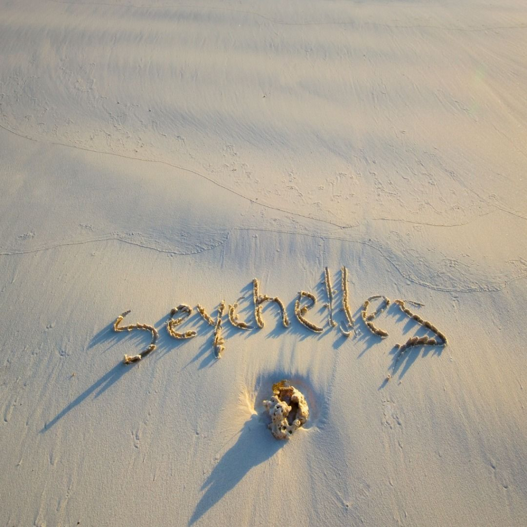'Seychelles' spelt out on white beach sand